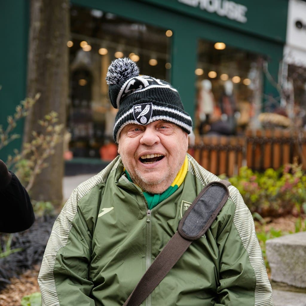 Portrait photo of older man with a warm smile used as source for caricature comparison