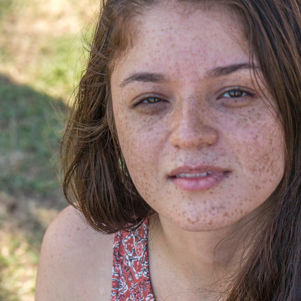 Portrait photo of teenager with freckles and short hair used as source for caricature comparison
