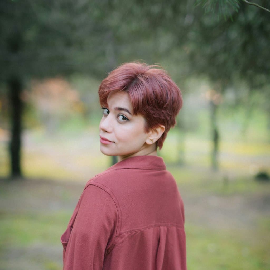 Portrait photo of woman with short hair and a warm expression used as source for caricature comparison